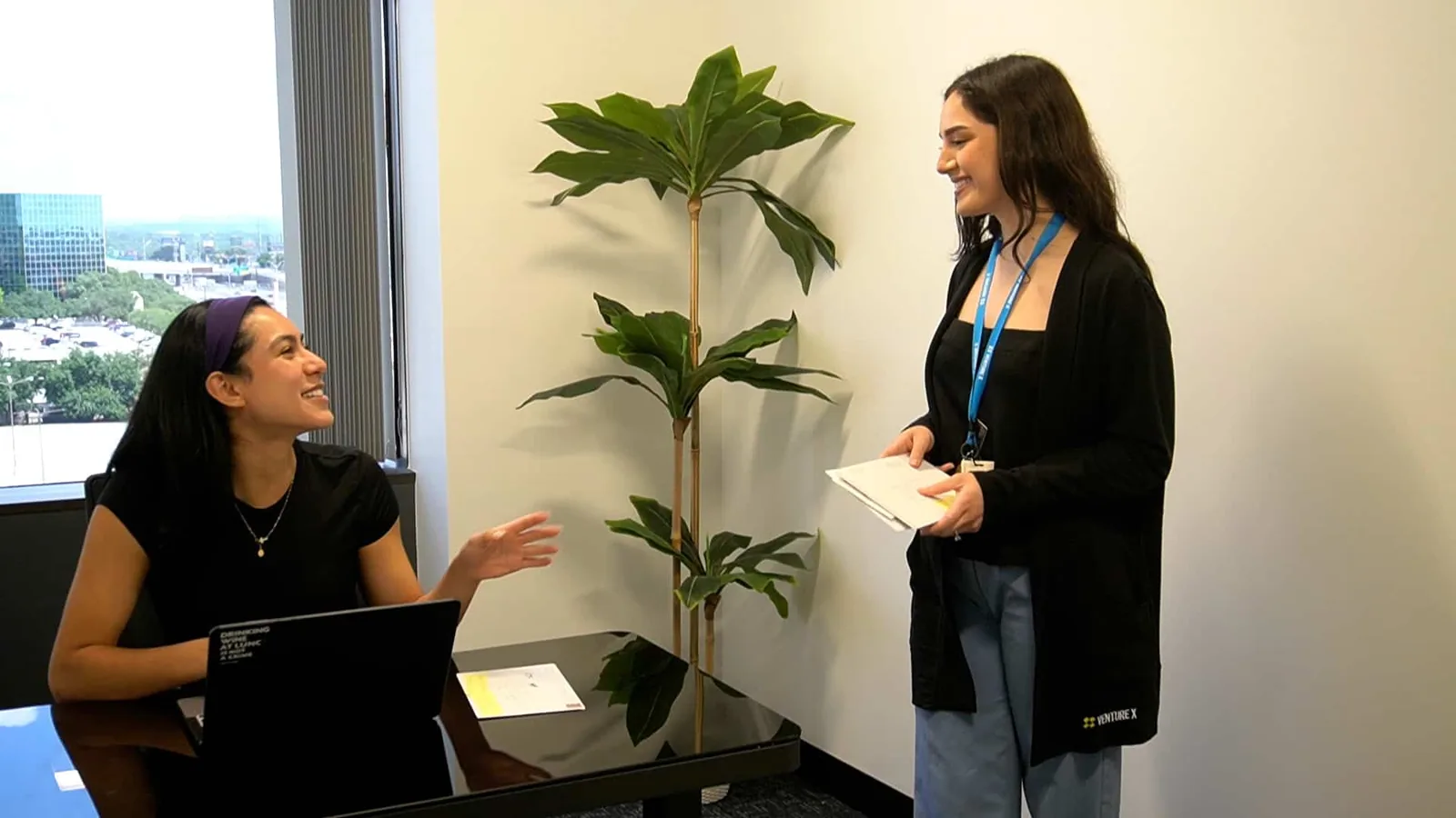 SA Cowork staff delivering mail to a member working in a San Antonio virtual office