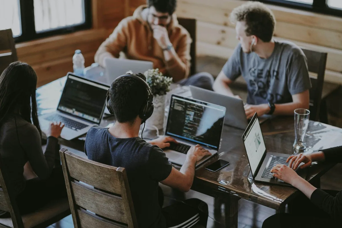 Professionals working in a flexible shared workspace as office behavior shifts toward hybrid and coworking models