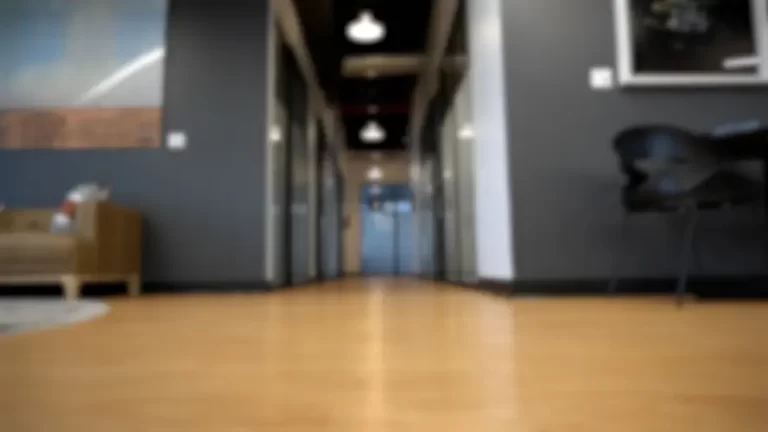 A blurred photograph of a San Antonio Coworking Space with conference rooms rentals, private offices and virtual offices